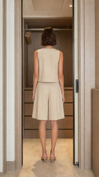Back view of woman in beige sleeveless top and shorts set