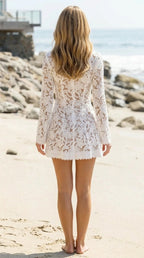 Back view of woman in white lace mini dress