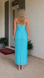 Back view of model in turquoise strapless maxi dress