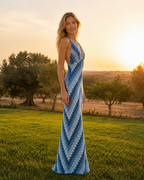 Side view of blue chevron halter maxi dress with floor-length silhouette