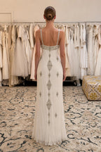 Back view of ivory beaded evening gown showing spine embellishments