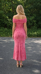 Model wearing pink off-the-shoulder ruched floral midi dress, back view