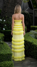 Model wearing yellow tiered fringe strapless maxi dress from back view
