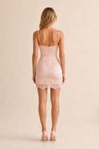 Back view of pink satin mini dress with lace trim