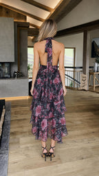 Back view showcasing open back design of black floral dress