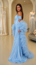 Side profile of light blue mermaid gown with dramatic feather cape