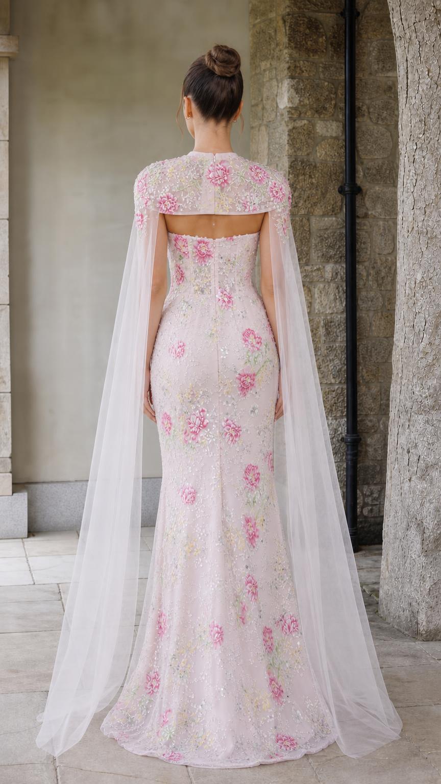 Back view of pink gown showcasing the sweeping sheer cape