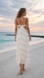 Back view of ivory tiered fringe maxi dress with slim straps and open back