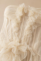 Close-up of structured bodice and ruffled tulle appliqués