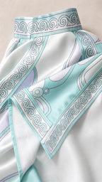 Close-up detail of satin fabric and swirl pattern on light blue dress