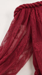 Close-up detail of braided neckline and lace texture
