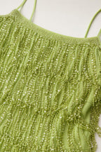 Close-up detail of green sequin and bead fringe texture