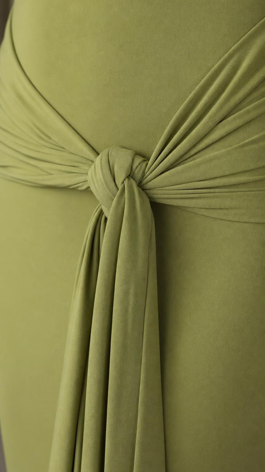 Close-up detail of the front waist knot and drape on the olive dress