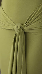 Close-up detail of the front waist knot and drape on the olive dress