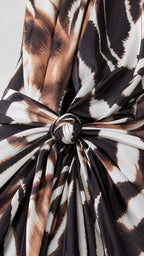 Close-up detail of the front twist knot on animal print dress