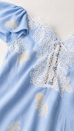 Close-up of lace bodice and button trim on Light Blue dress