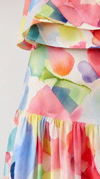 Close-up detail of watercolor print fabric and tiered skirt hem
