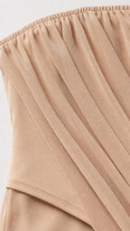 Close-up of gathered strapless neckline and draped fabric detail