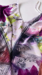 Close up fabric detail of white tropical print dress