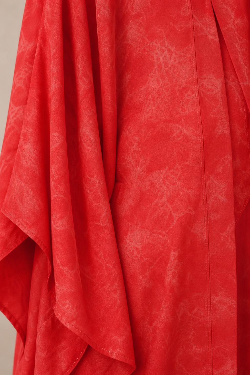 Close-up detail of red woven fabric with subtle tonal pattern