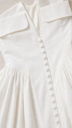 Close-up of white mini dress button and collar detail