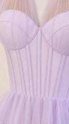 Close-up detail of the structured corset bodice and sheer neckline