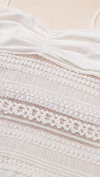 Close-up detail of lace midsection and ruched bodice