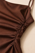 Close-up detail of side ruching and zipper on brown satin dress