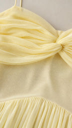 Close-up detail of bodice ruching and pleating on chiffon dress