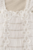 Close-up detail of crochet lace trim and square neckline