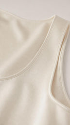 Close-up of scoop neckline and fabric texture in ivory
