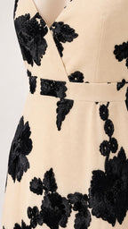 Close up of V-neckline and floral applique details