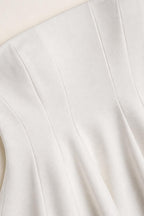 Close-up of white peplum top fabric and seaming details