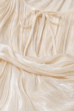 Close-up detail of fabric texture and tie neckline