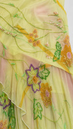 Close-up detail of floral embroidery and beadwork on mesh fabric