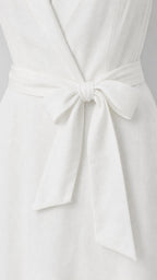 Close-up detail of self-tie bow belt on white dress