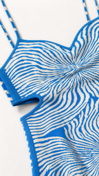 Close-up detail of bodice and side cutout design on blue knit dress