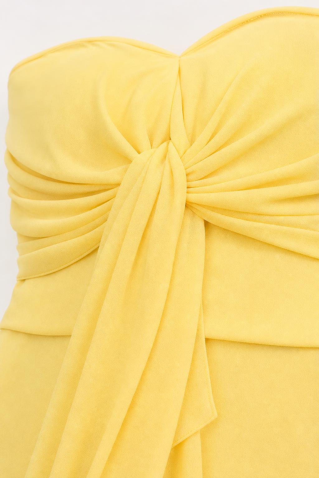 Close-up of ruched knot detail on bodice