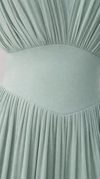 Close-up detail of bodice pleating and waist band on Sage Green dress