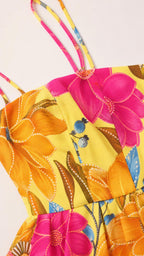 Close-up detail of the bodice, straps, and floral print fabric