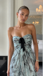 Close-up of abstract sage print sweetheart bodice with black bow accent