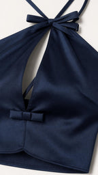 Close-up detail of navy halter necktie and front bow accent