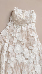 Close-up detail of high neckline and floral lace texture