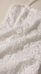 Close-up detail of white 3D floral lace fabric