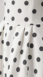 Close up of pleated waist and polka dot fabric detail