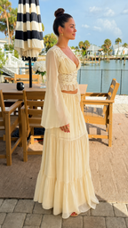 Side view of cream sheer sleeve crop top and maxi skirt set