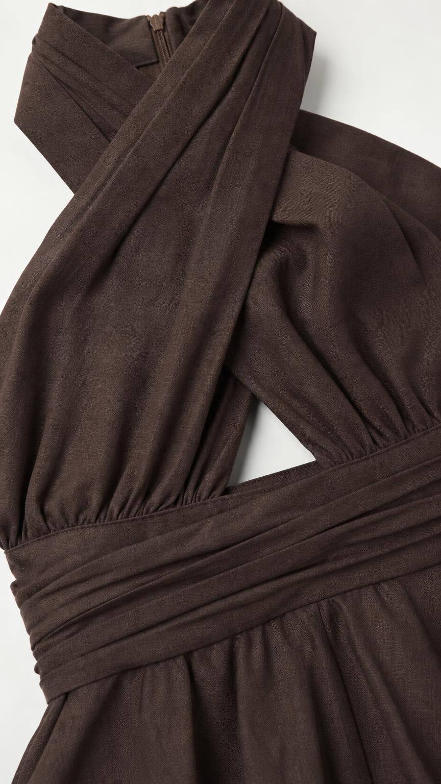 Close-up of the chocolate brown halter neckline, waist seam, and smooth-looking woven fabric