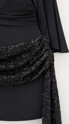 Close-up of sequin embellished waist sash and drape sleeve