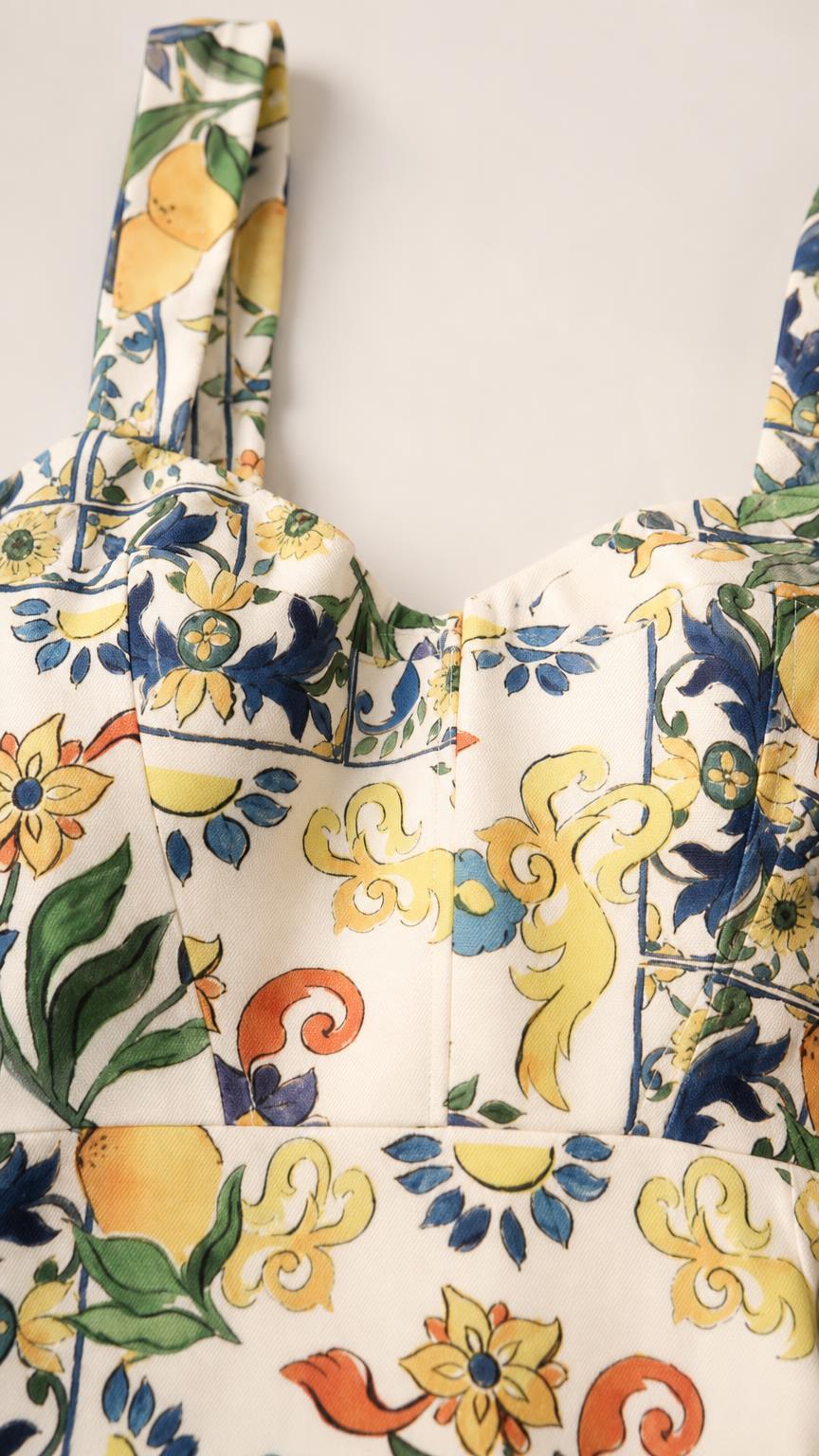 Close-up detail of straps and square neckline on white floral dress