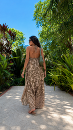 Back view of taupe printed backless halter pants set with full-length wide leg silhouette